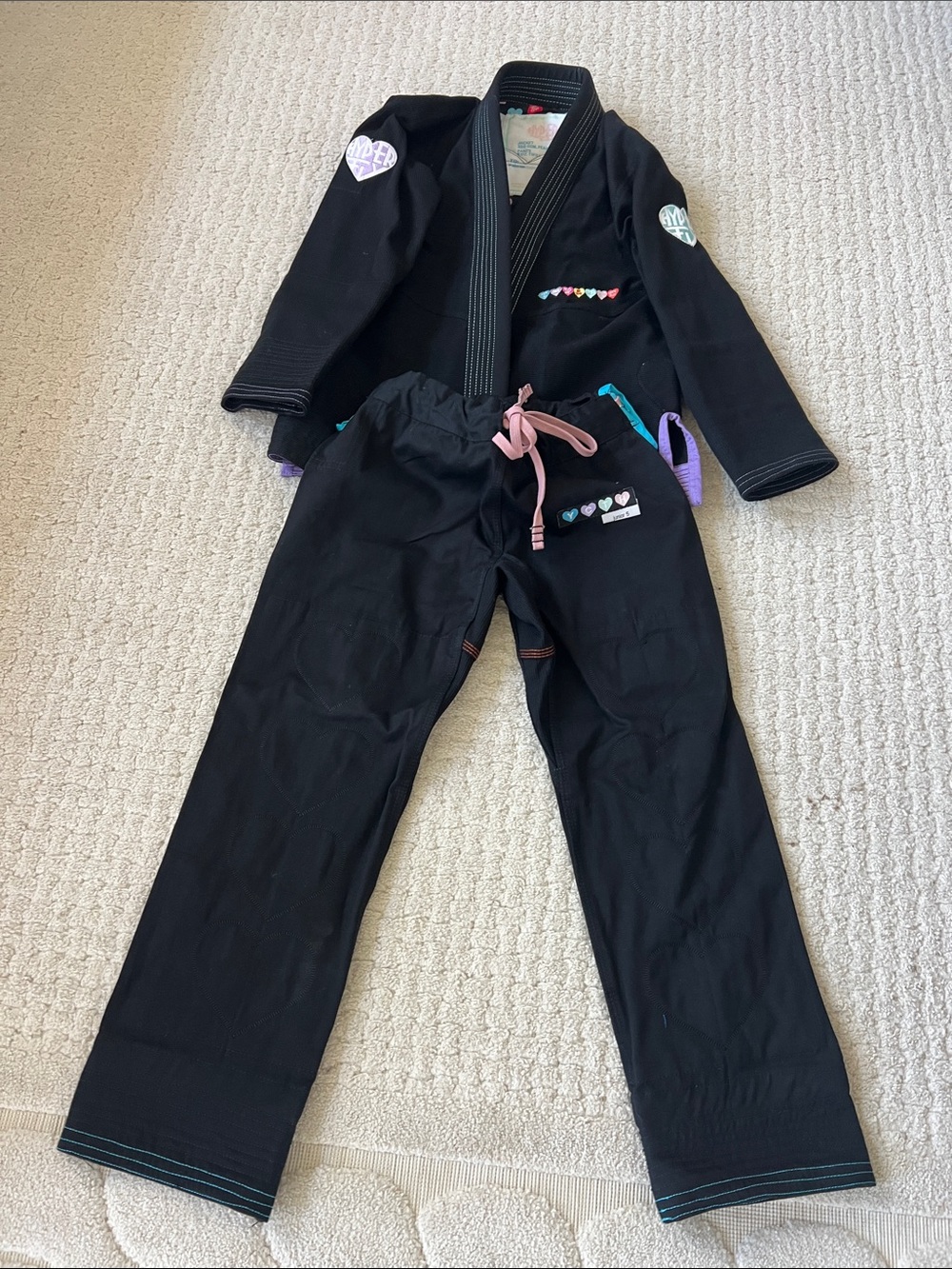 Hyper Fly black Gi with subtle hearts. Never been worn. Junior Size 5.